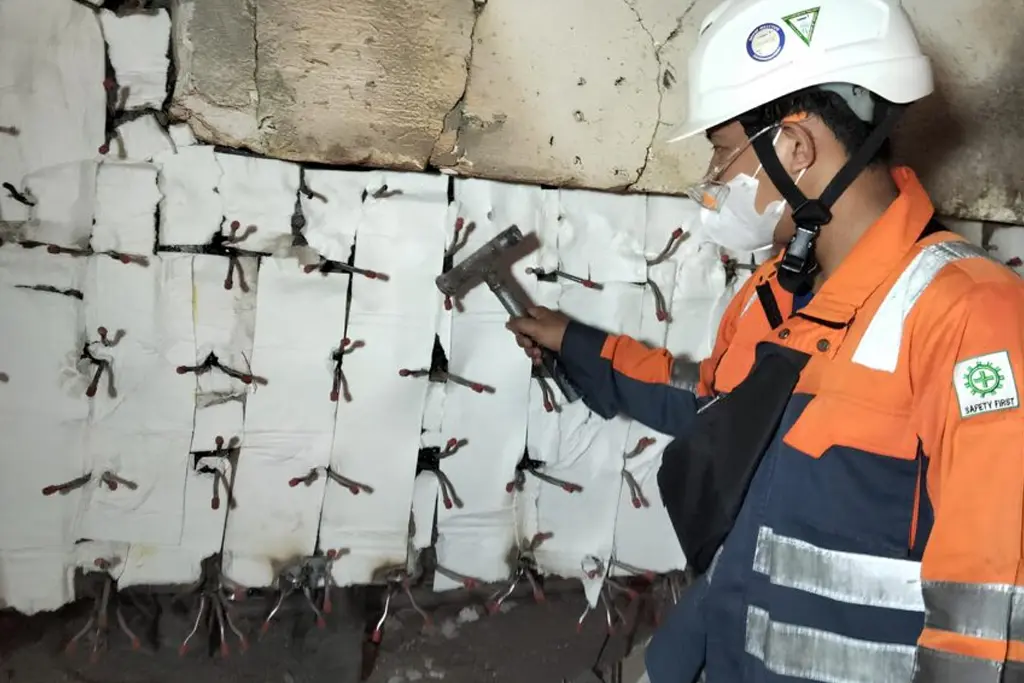 Removing refractory pins inside a kiln