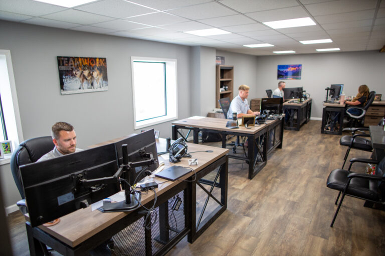 Midwest Wire Group sales and customer service team working at desks in a modern office environment.