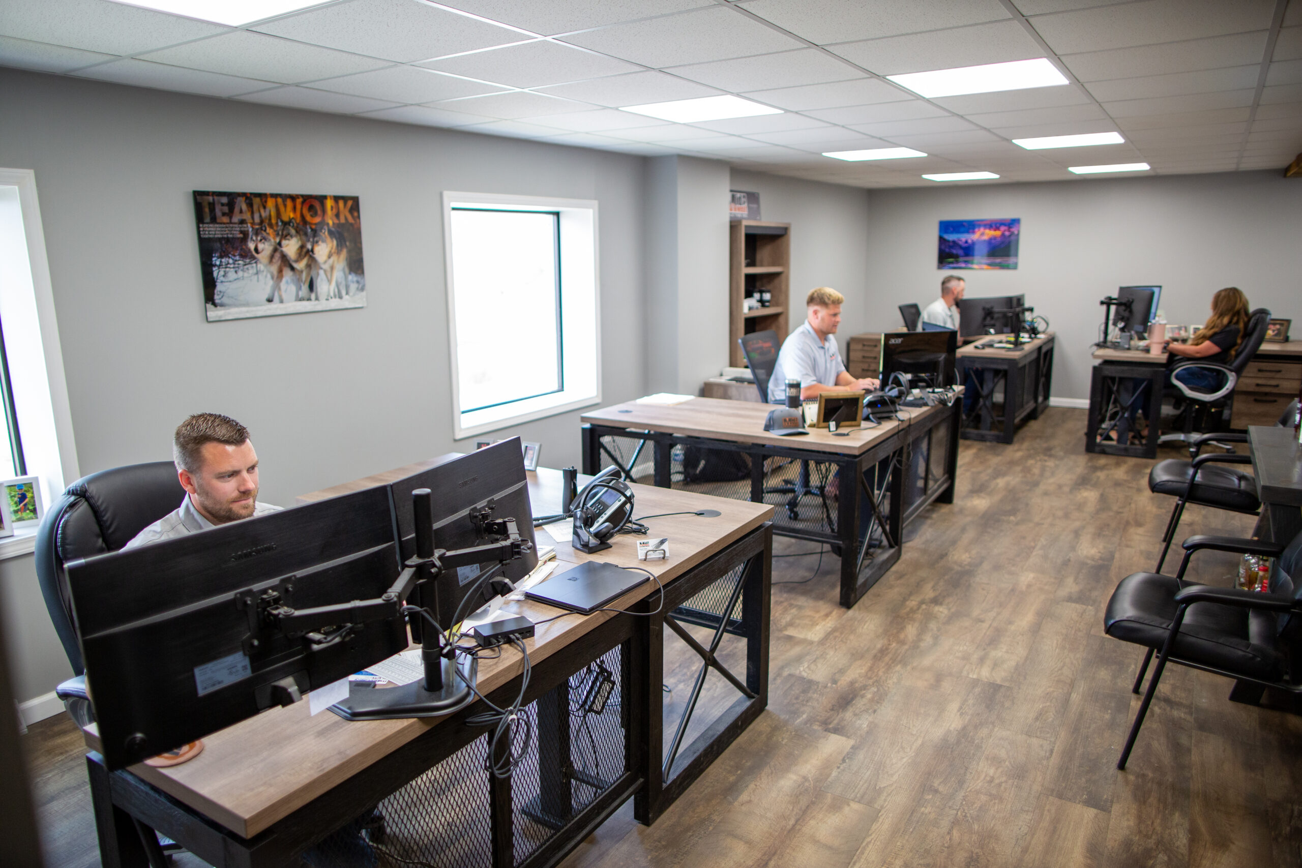 Midwest Wire Group sales and customer service team working at desks in a modern office environment.