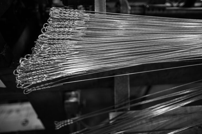 Close-up view of freshly manufactured bale ties stacked together, showcasing the twisted loop ends and precision craftsmanship.